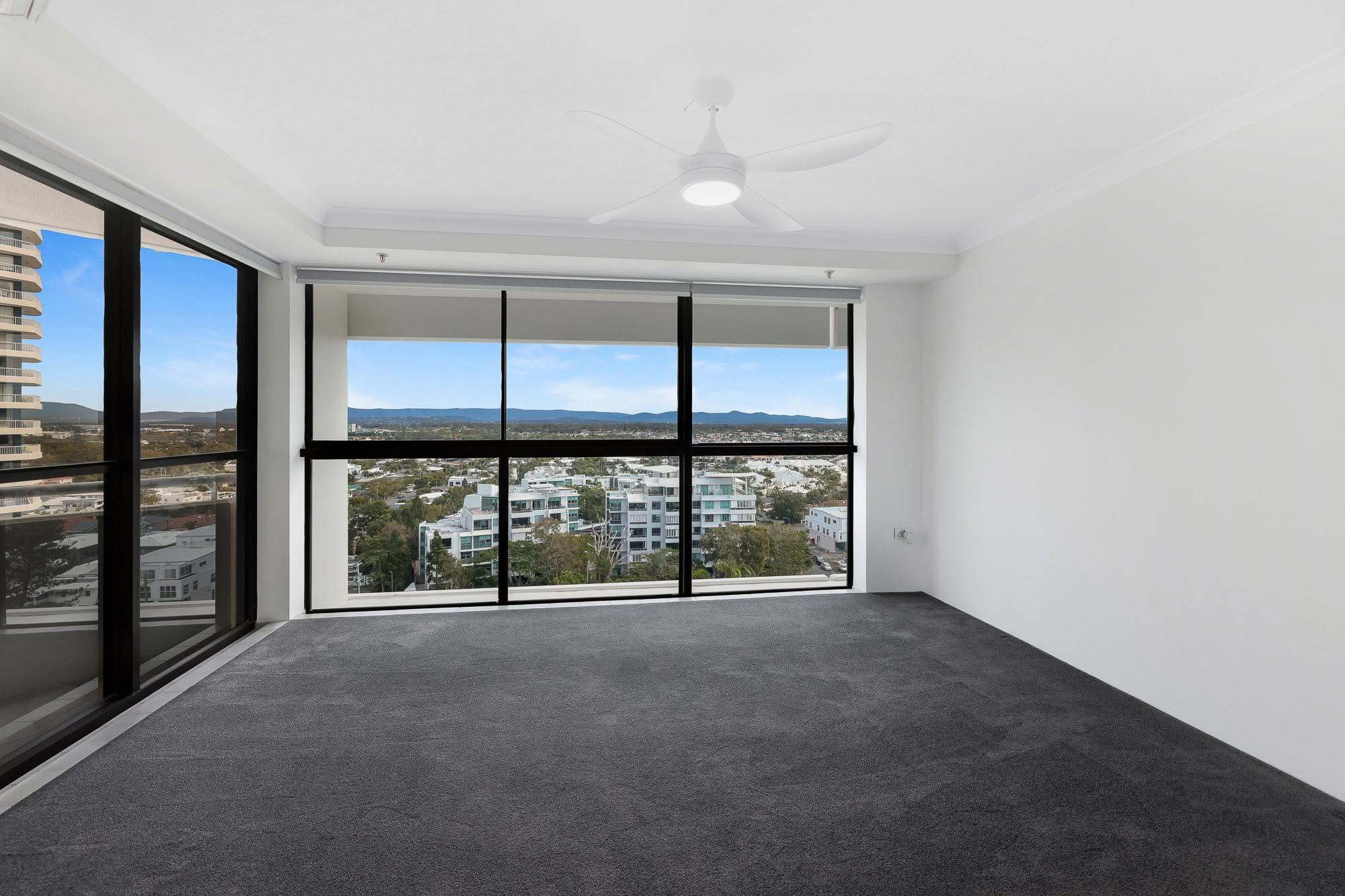 Bedroom with wide windows in a Leeward Tower residence