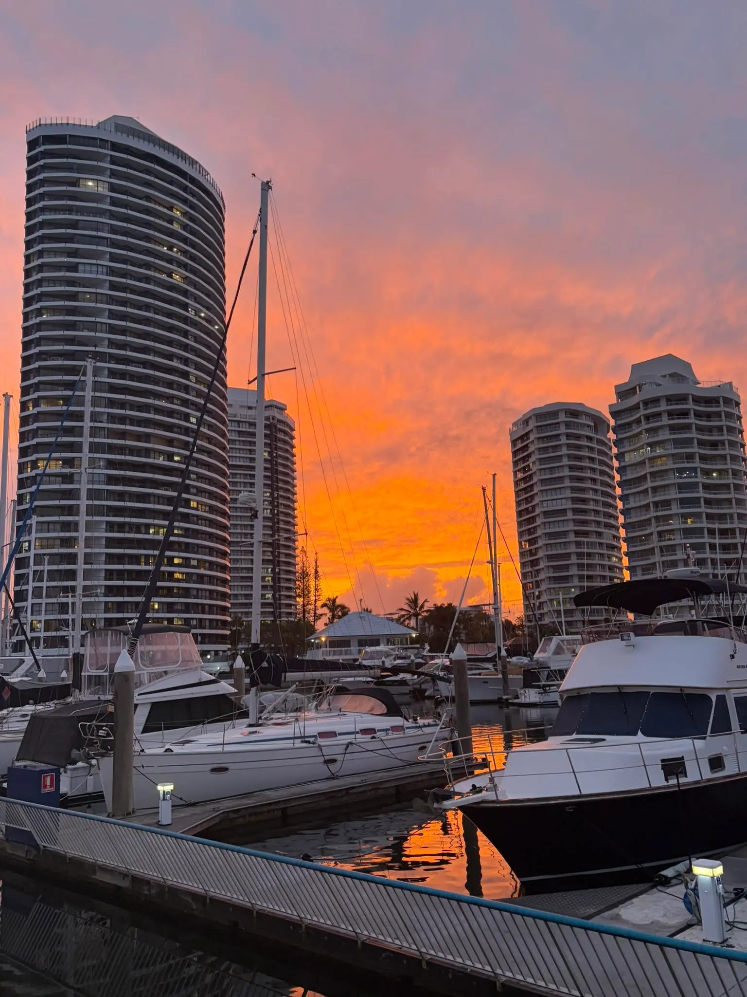 Runaway Bay Marina at sunset with residential towers behind the moored boats